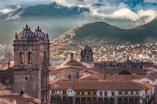 Morning sun rising with cloudy on Aden Mountain at Plaza de armas, Cusco, Peru © sharptoyou/Shutterstock